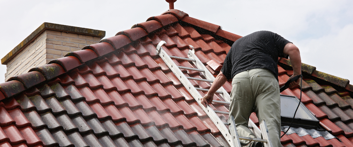 Man standing on roof brick roof tile. 